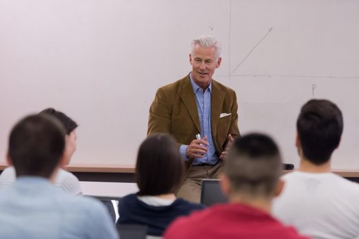 group of students study with professor in modern school classroom