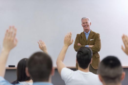 group of students study with professor in modern school classroom