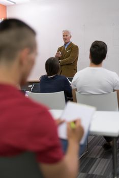 male student taking notes in classroom. business education concept, casual young businessman on seminar training