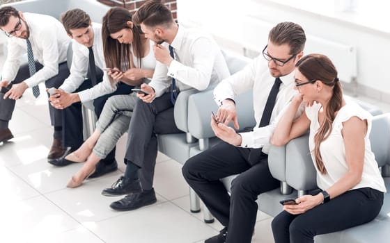 business team sitting in the lobby of the business center .business concept