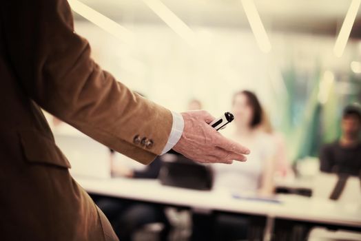 close up of teacher hand with marker while teaching lessons in school  classroom to students