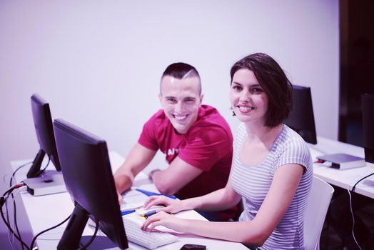 technology students group in computer lab school  classroom working on