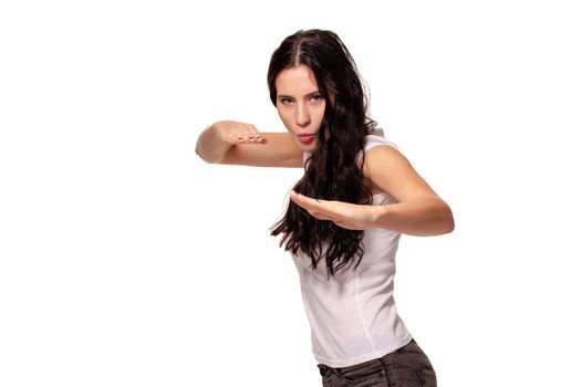 Beautiful woman shows martial art exercise on white background