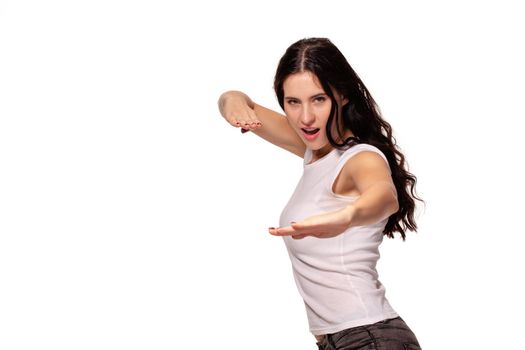 Beautiful woman shows martial art exercise on white background