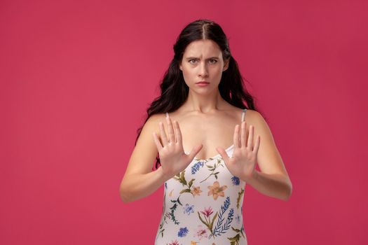 Attractive woman saying thanks but no. Beautiful girl denying proposal, making stop gesture