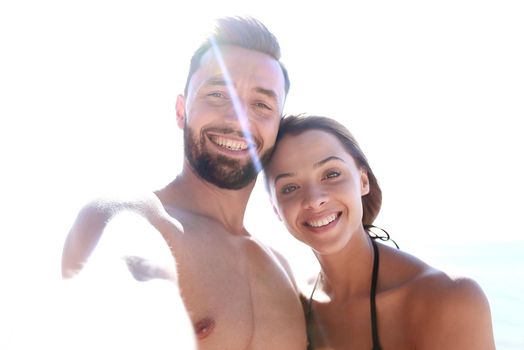 Romantic couple taking selfie on the beach.