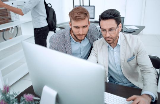 two businessmen look at the computer monitor.people and technology