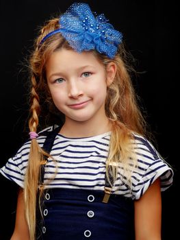 Beautiful little girl studio portrait on a black background. Close-up.