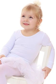 Happy little girl , a future figure skater, sits on a chair in a White sports dress , close-up-Isolated on white background