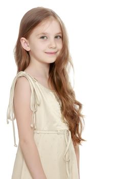 Beautiful little girl with long brown hair to her waist . The girl smiles sweetly turning sideways to the camera. Close-up - Isolated on white background - Isolated on white background