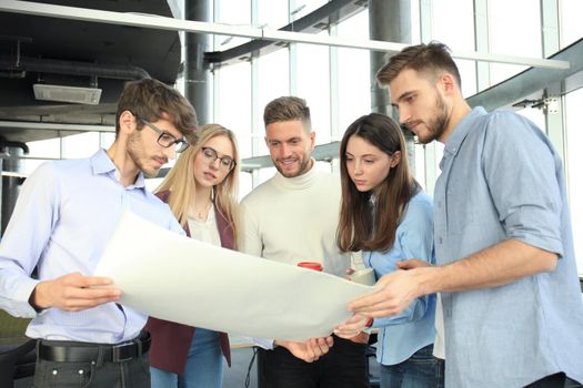 Group of young business people and designers in smart casual wear. They working on new project