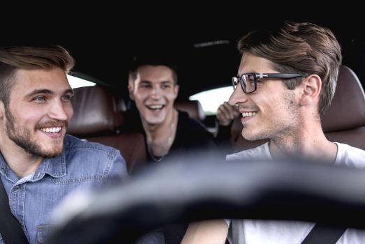 close up. friends give each other a high five sitting in the car