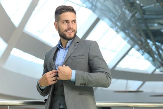 Young handsome businessman smiling in an office environment