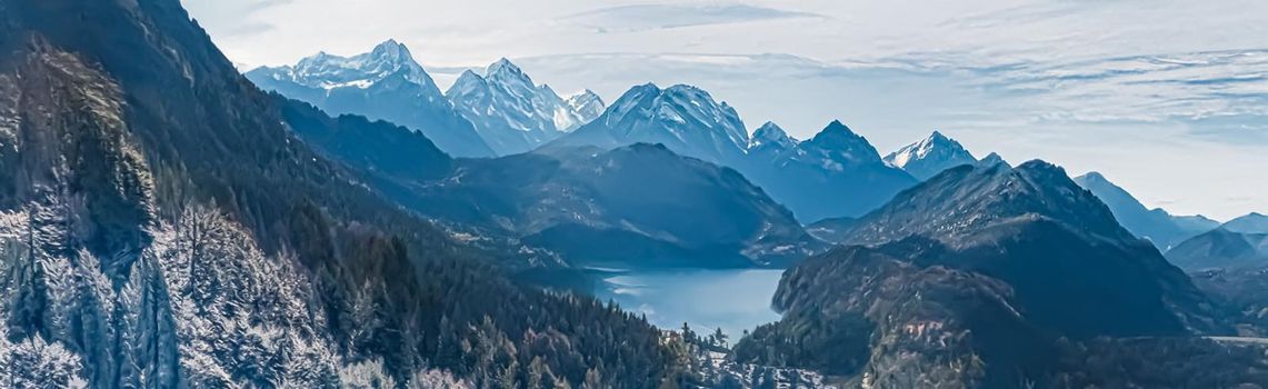 Winter wonderland and magical Christmas landscape. Snowy mountains and forest covered with snow as holiday background.