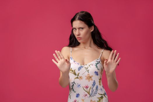 Attractive woman saying thanks but no. Beautiful girl denying proposal, making stop gesture