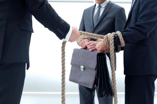 close up. a group of young businessmen tied with a rope .business concept