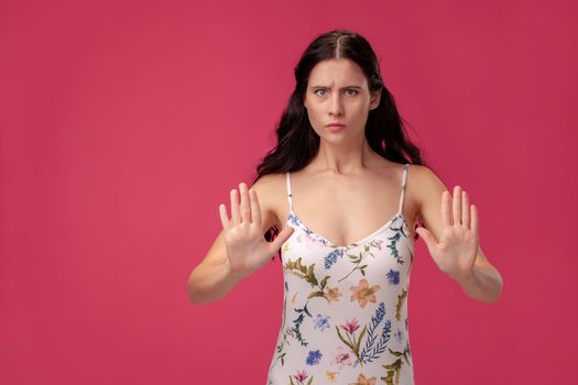Attractive woman saying thanks but no. Beautiful girl denying proposal, making stop gesture