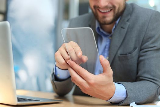 Future concept. Businessman holds futuristic transparent smart phone