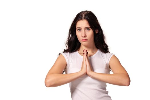 A close up image of a beautiful woman praying with her hands foldedand isolated for white background