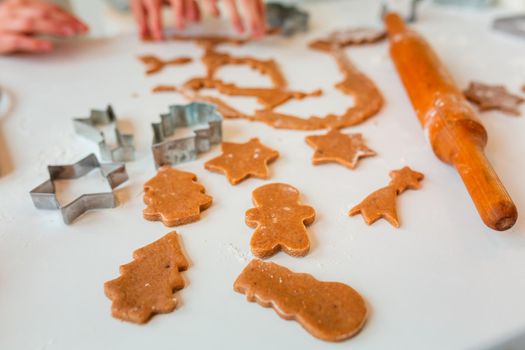 Christmas bakery. Friends making gingerbread, cutting cookies of gingerbread dough, view from above. Festive food, cooking process, family culinary, Christmas and New Year traditions concept