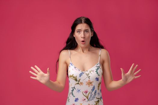 Image of excited screaming young woman on the pink background