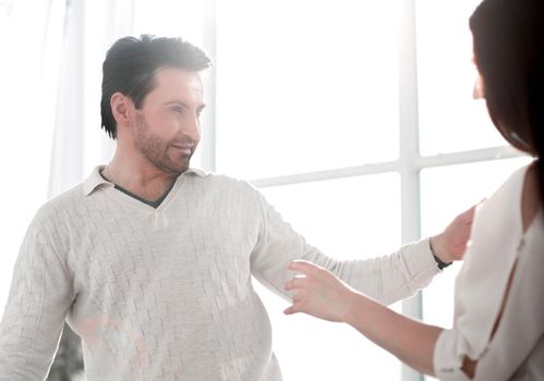 background image of a young couple standing near a window.photo with copy space