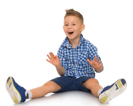 Joyful little boy sitting on the floor with legs apart - Isolated on white background