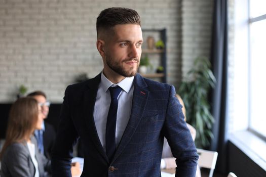 Businessman with colleagues in the background in office