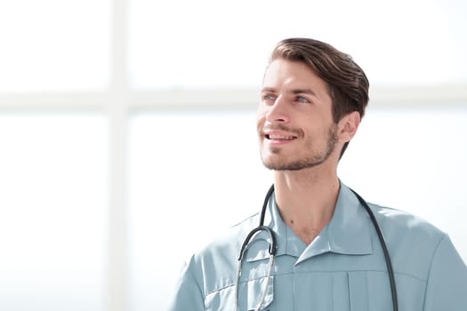 portrait of a friendly doctor in blue uniform. photo with copy space