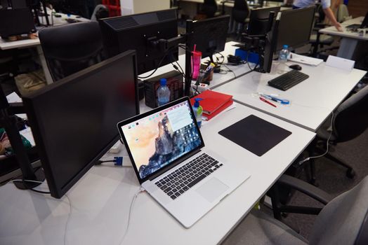 dual monitor screen and laptop computer at modern office indoors, startup company software develop  technology