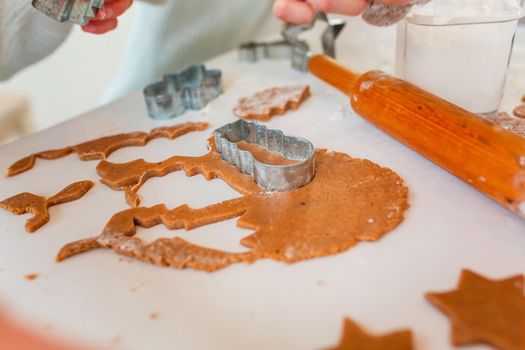 Christmas bakery. Friends making gingerbread, cutting cookies of gingerbread dough, view from above. Festive food, cooking process, family culinary, Christmas and New Year traditions concept