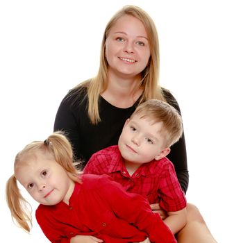 Happy young mother with two small children , a boy and a girl of preschool age.Isolated on white background