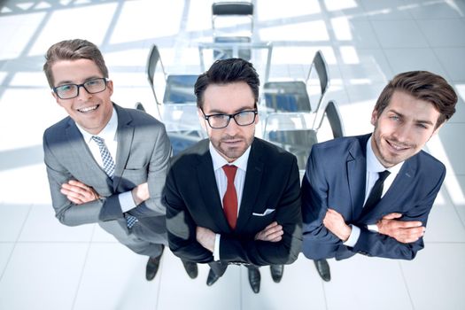 three confident businessman on background of office.business concept