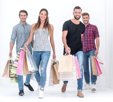 group of young people with shopping bags is stepping forward.isolated on white