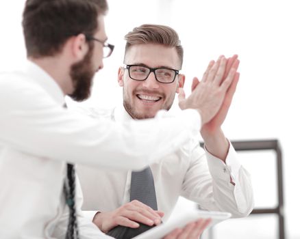 close up. two successful employees giving each other a high five .the concept of unanimity