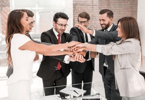 professional business team making tower out of their hands. the concept of teamwork