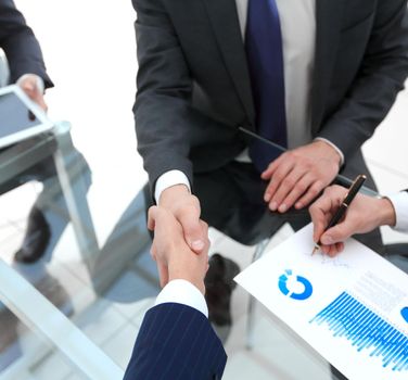 handshake of financial partners at the Desk.