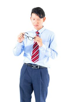 Male wearing blue shirt and red tie reaching posing in studio isolated on white background with clipping path