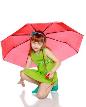 A little girl with long blond hair and a short bangs, in a short summer dress.The girl closed from the sun and rain under a red umbrella.