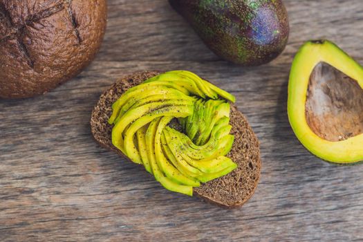 Avocado sandwich on dark rye bread made with fresh sliced avocados.