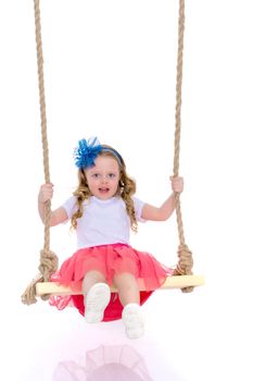 Beautiful little girl swinging on a swing. The concept of family happiness, summer holidays. Isolated on white background.