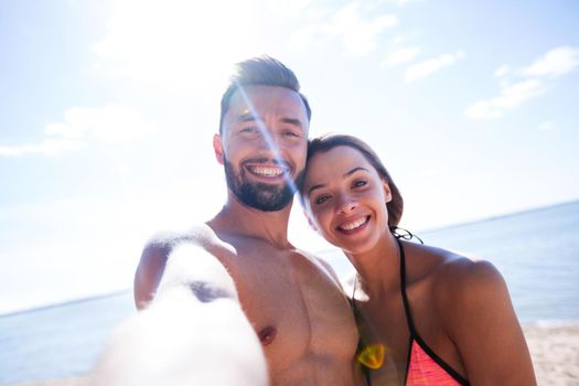 Romantic couple taking selfie on the beach.