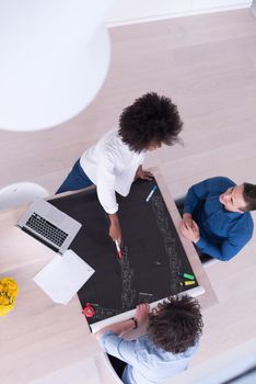 Multiethnic startup business team on meeting in modern bright office interior brainstorming, top view