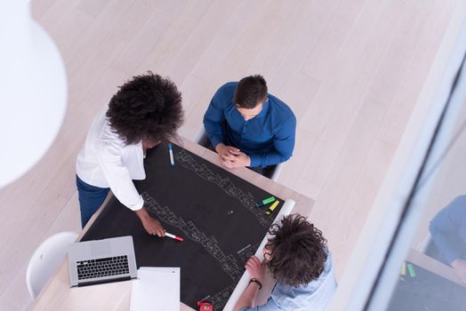 Multiethnic startup business team on meeting in modern bright office interior brainstorming, top view