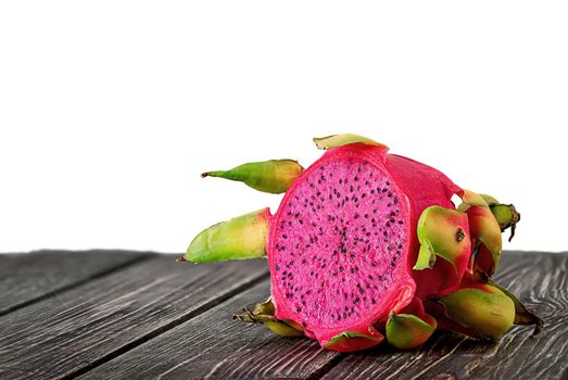 Half dragon fruit on planks isolated on white background