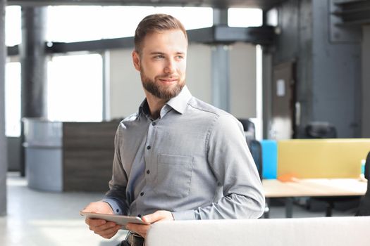 Young man using his tablet in the office