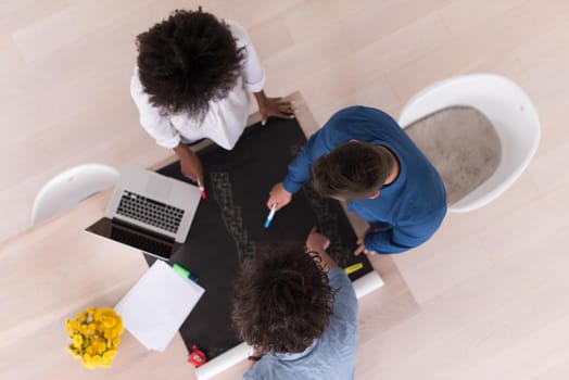 Multiethnic startup business team on meeting in modern bright office interior brainstorming, top view