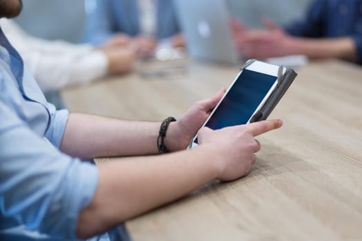 young casual businessman using tablet computer in startup office