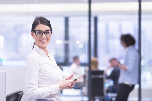 female manager using cell telephone in startup office interior