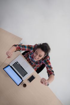 top view of young business woman working on laptop computer in modern bright startup office interior